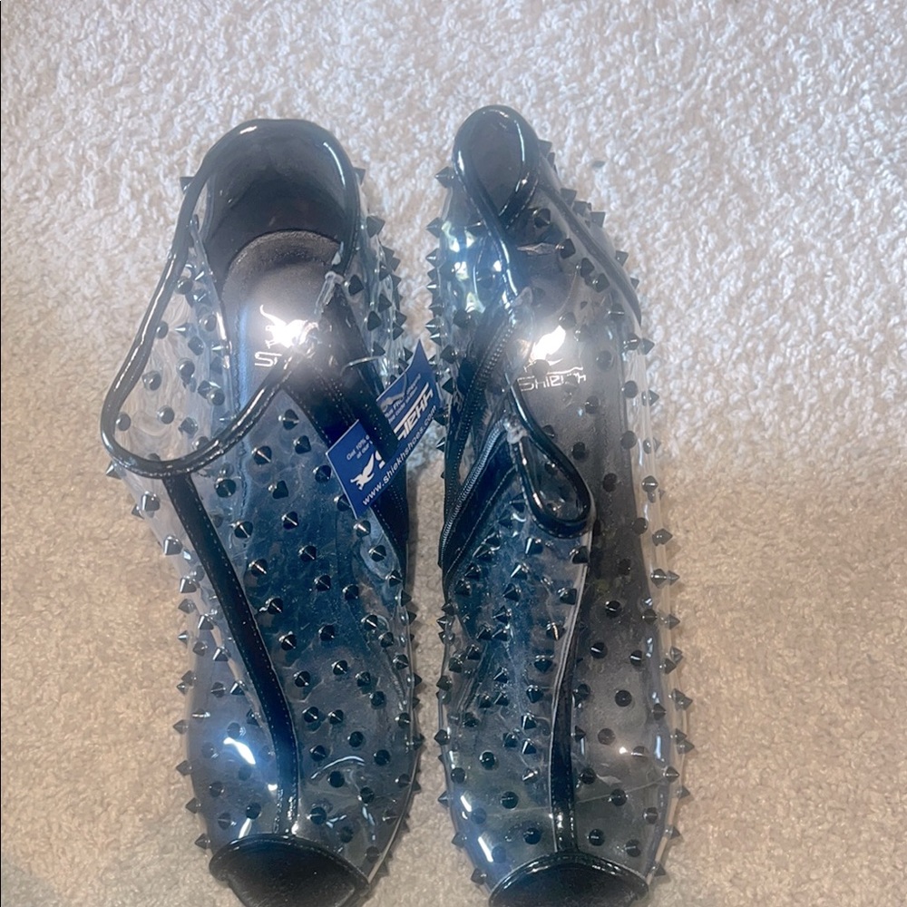 Take a walk on the wild side with these size 9 Clear and Black Spiked wedge